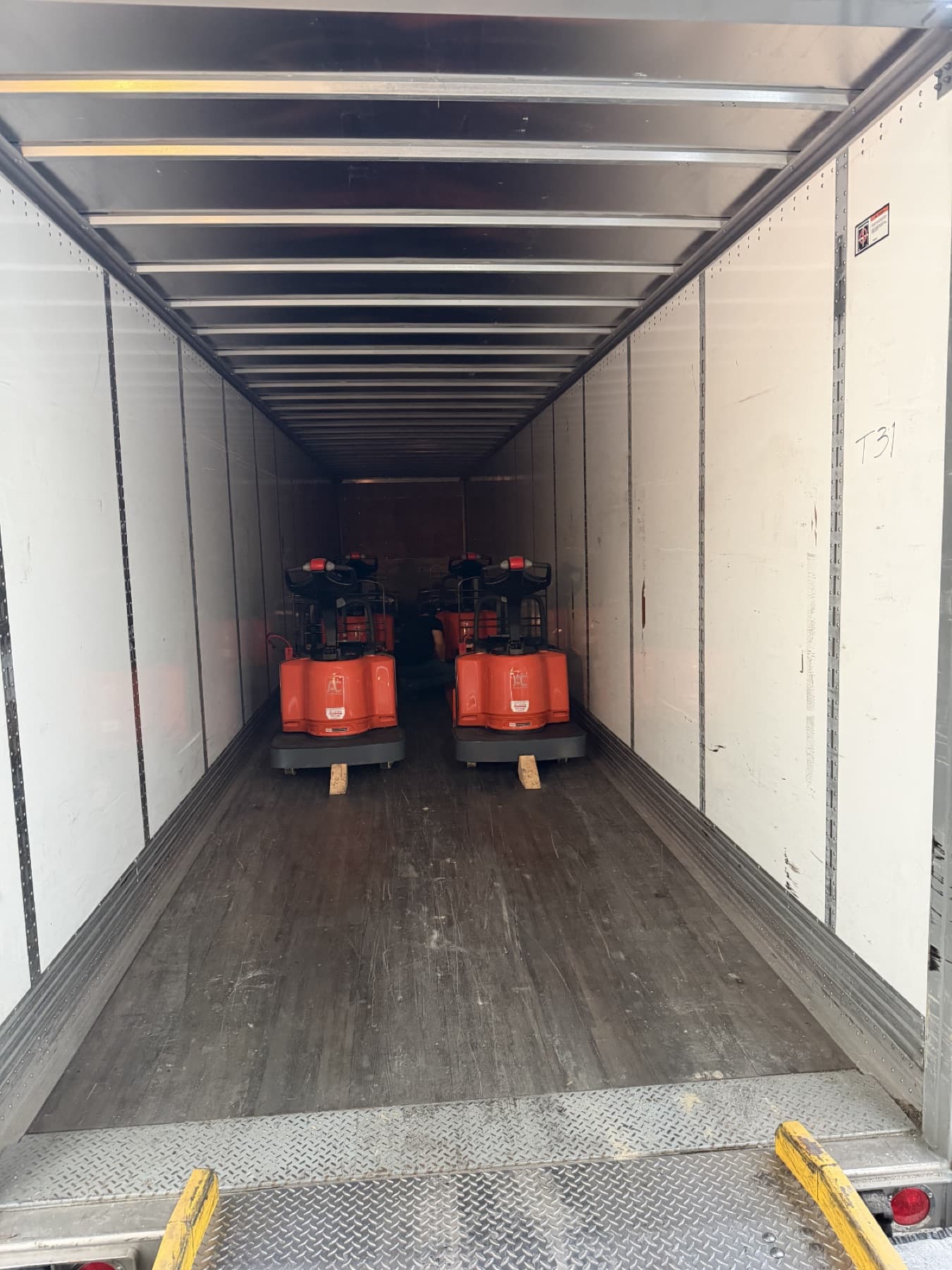 Electric pallet jacks loaded and chocked